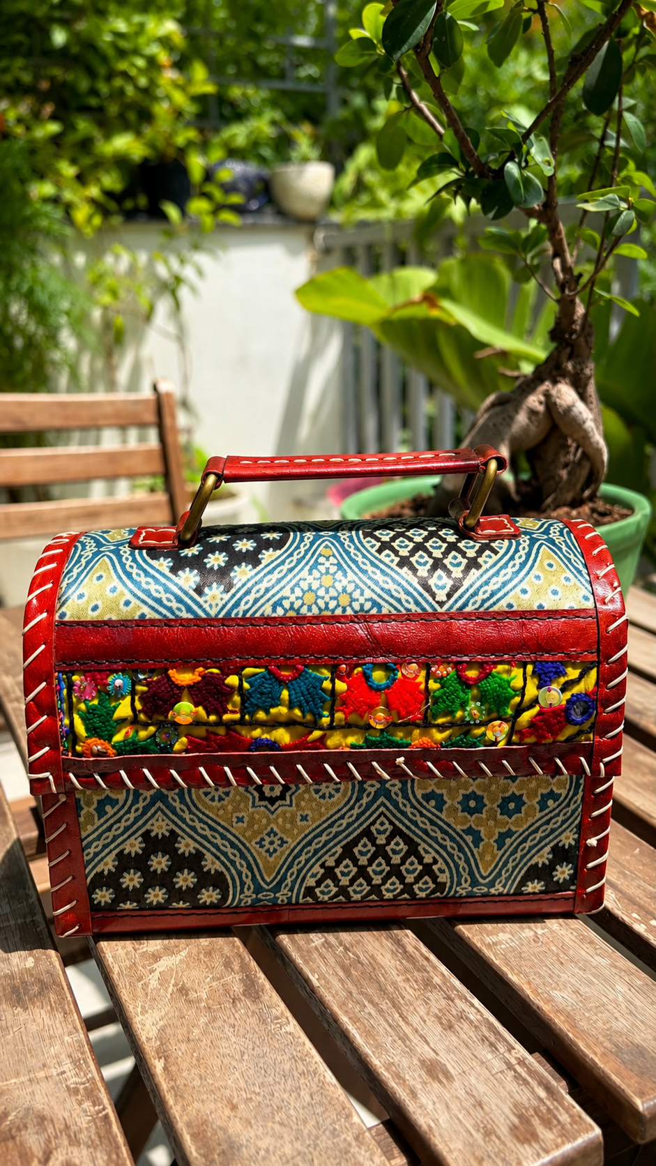 Black Banjara trunk bag — side view showing Banjara embroidery panel