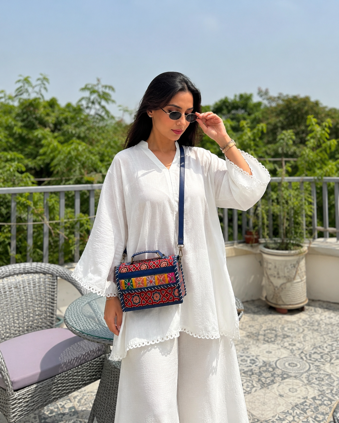 Multicolour Banjara crossbody trunk bag — lifestyle on rooftop