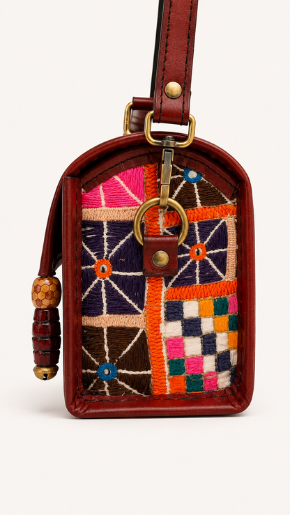Brown leather cowrie shell trunk bag, third view