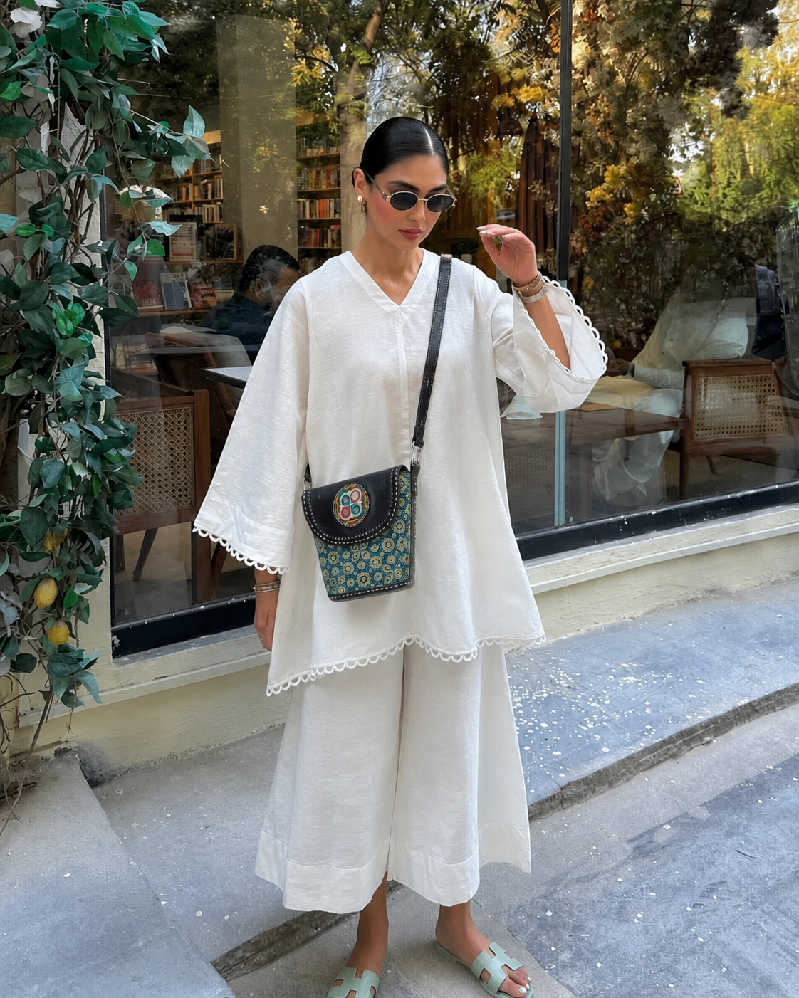 Navy blue Ajrakh crossbody bag — lifestyle shot in bookstore